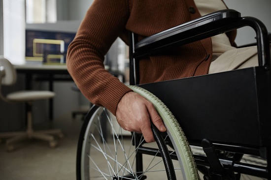 Hands Turning Wheelchair Wheel